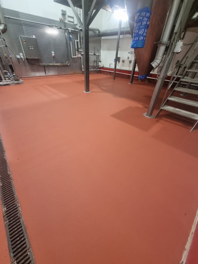 Hygienic resin flooring for food and beverage production and processing environments