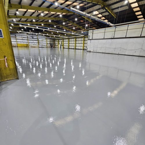 Commercial resin flooring installation Commercial resin flooring installed in a high-traffic industrial environment