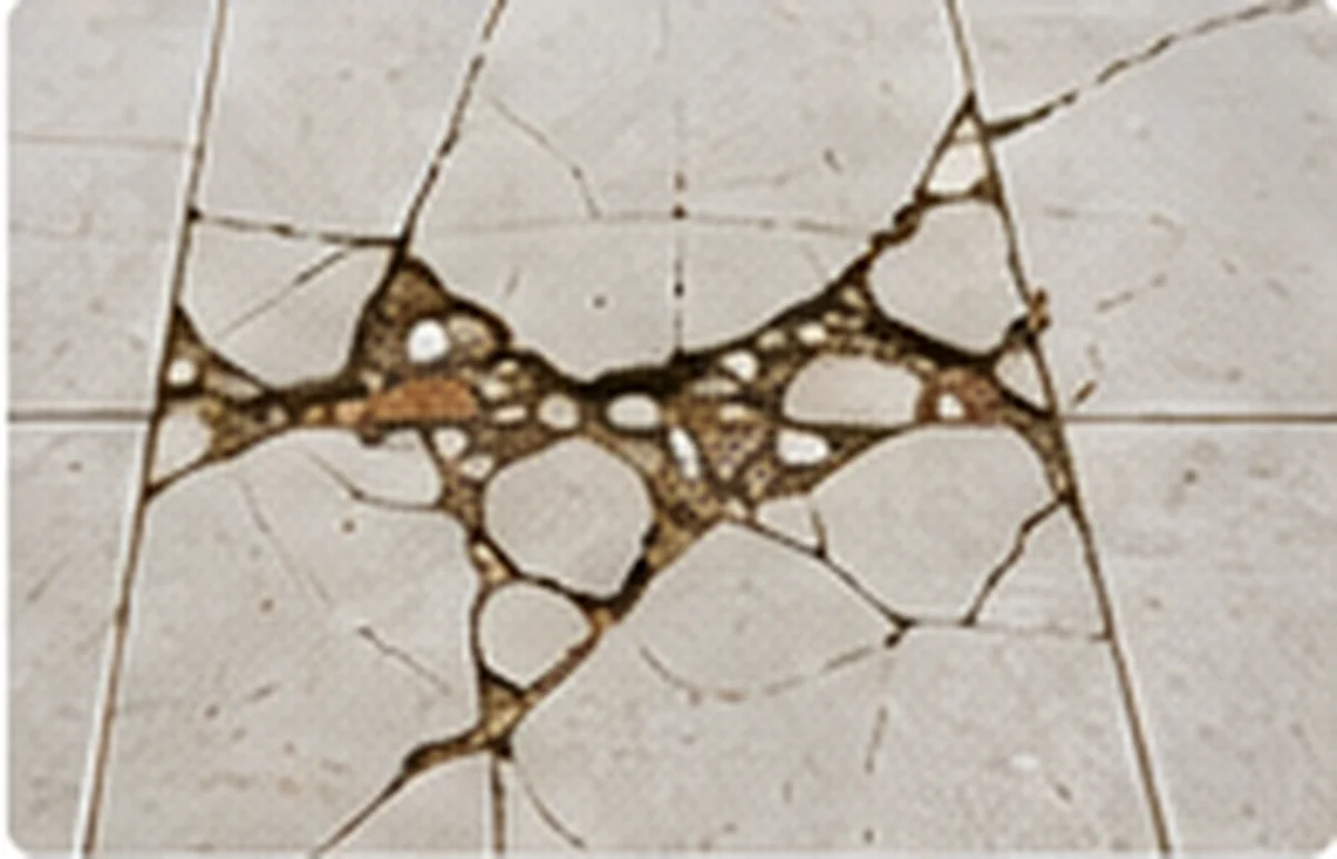 Cracked and damaged floor tiles with failed grout joints
