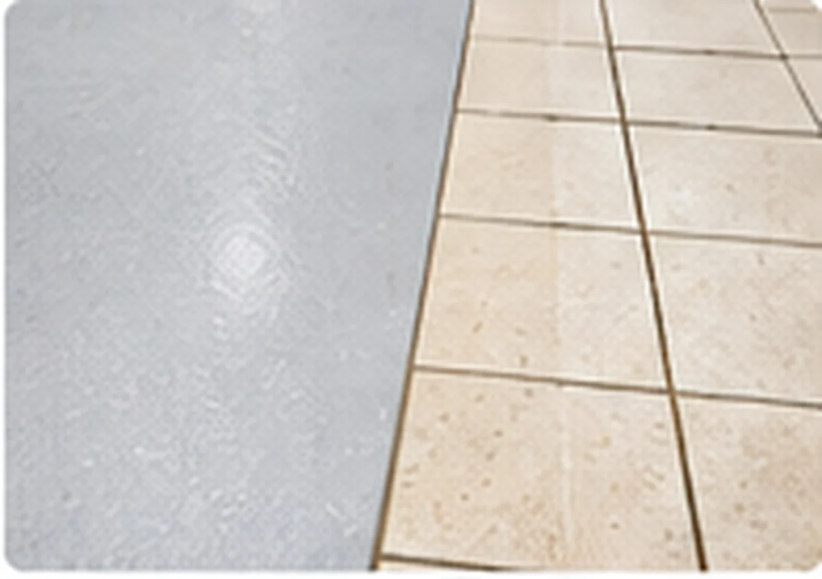 Seamless resin flooring beside a tiled floor with grout joints