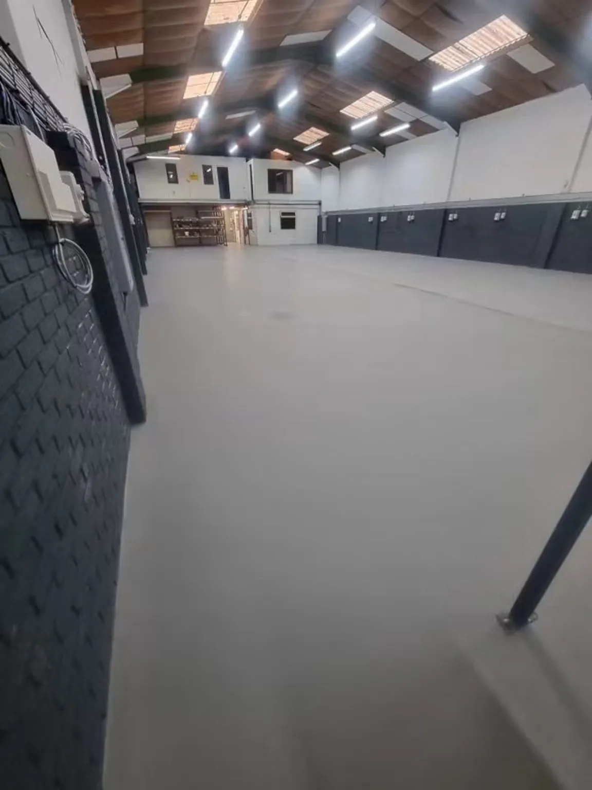 Completed dark grey 9mm Resdev Pumadur HF polyurethane flooring in Cardiff training centre