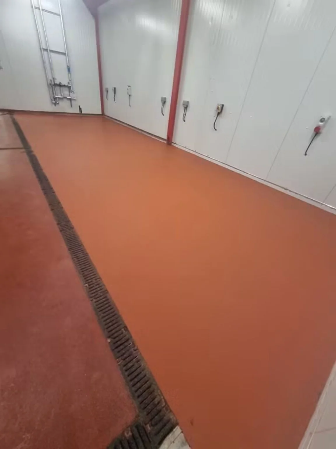 RAL 3001 polyurethane food factory flooring finished around channel drainage in Ebbw Vale