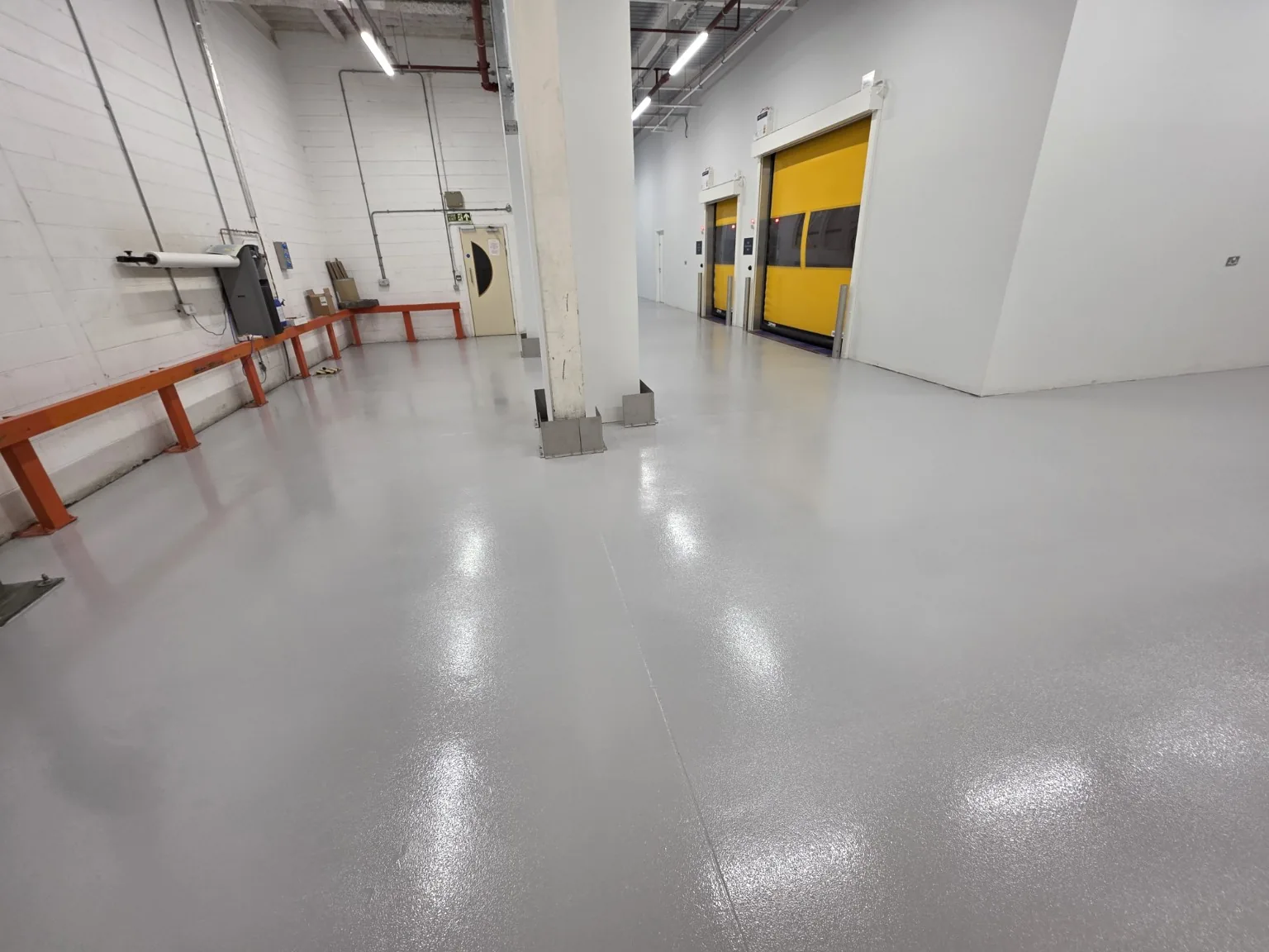 Completed grey high-build epoxy floor coating in a factory production area