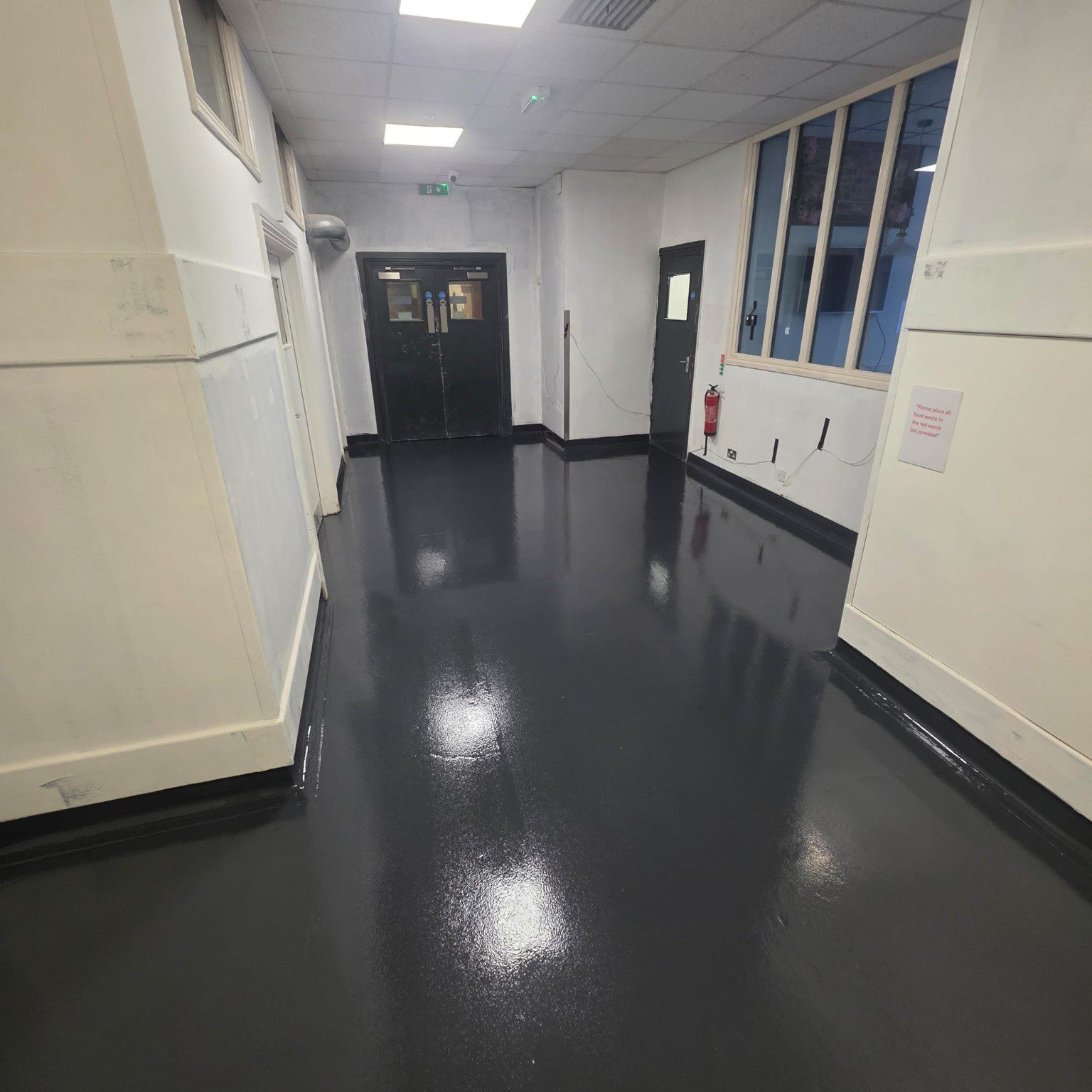 Finished dark resin floor in Novotel hotel back-of-house service area