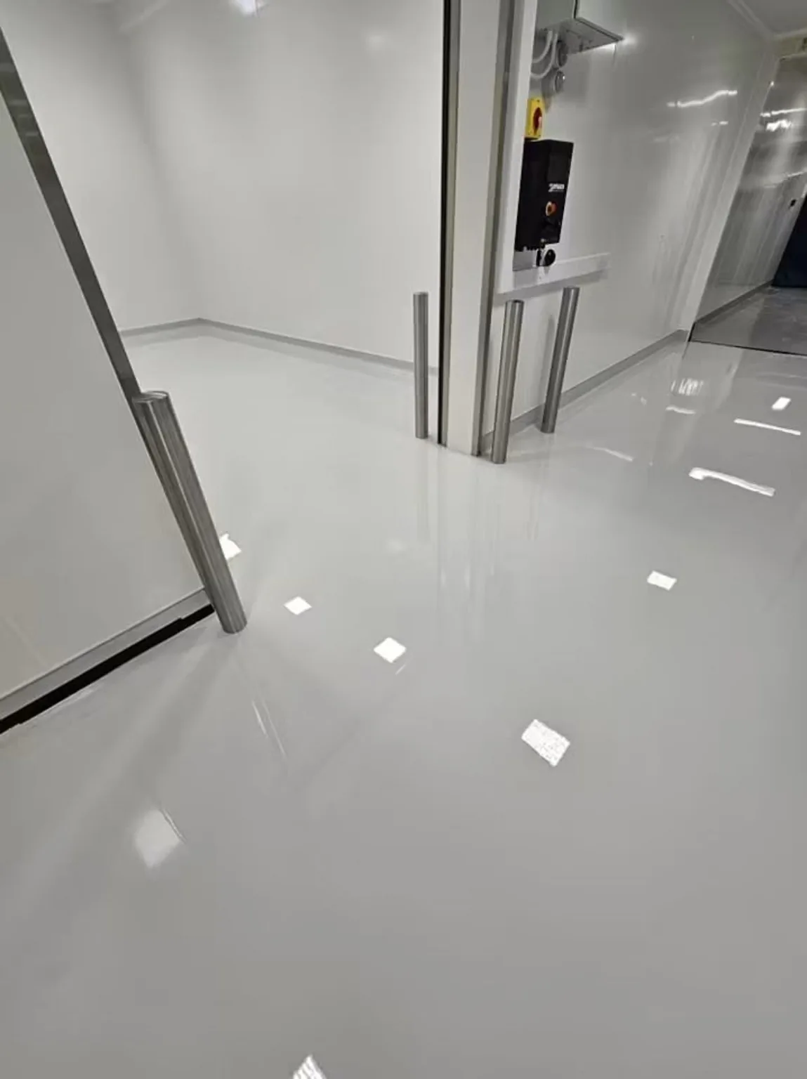 Pharmaceutical resin flooring with coved perimeter and detailed doorway transition