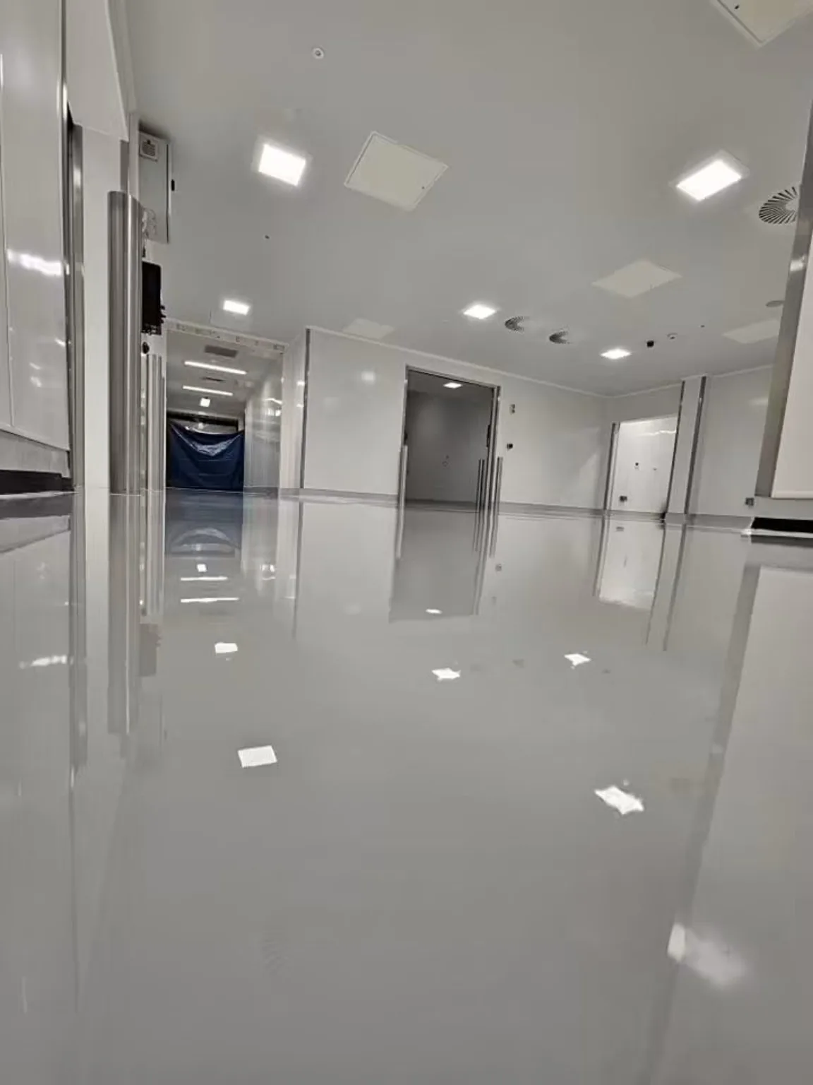 Glossy self-levelling resin floor across a large pharmaceutical manufacturing area
