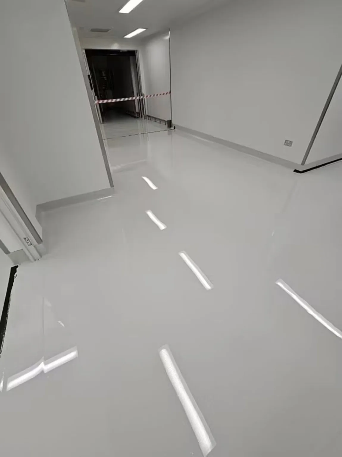 Pharmaceutical resin flooring South Wales project showing completed self-levelling resin flooring in a manufacturing corridor