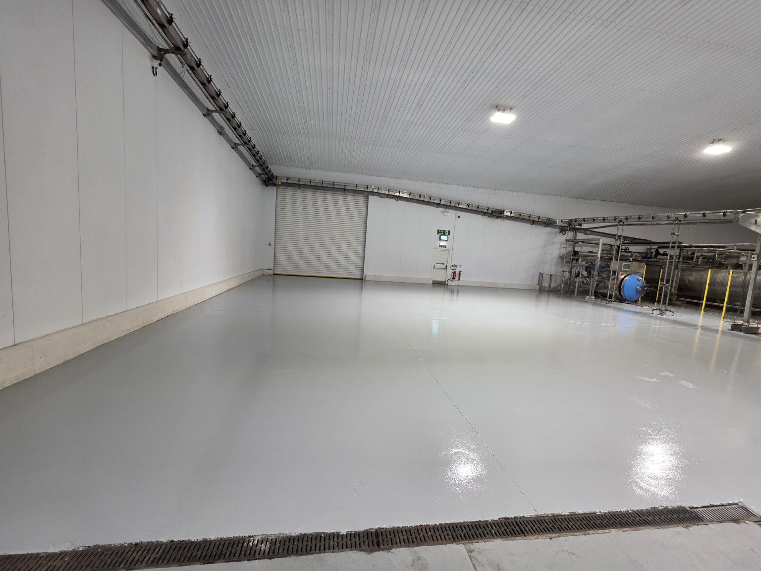 Finished grey resin warehouse floor with drainage channel