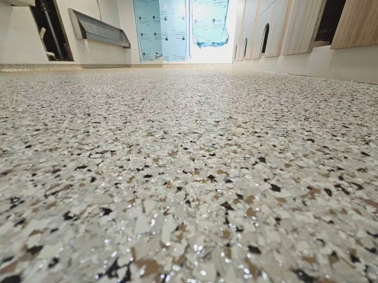 Close-up of the speckled aggregate finish on a grey MMA resin floor installed in Cardiff.