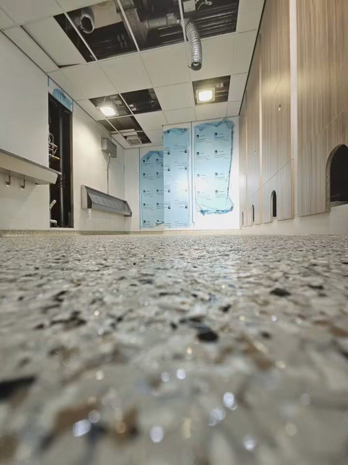 Low-level view across completed grey speckled MMA resin flooring in Cardiff.