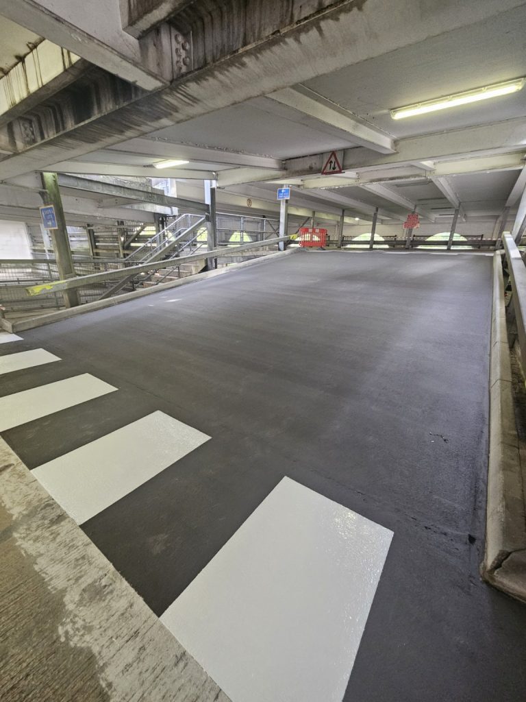 Completed internal car park resin surface with white crossing markings in South Wales